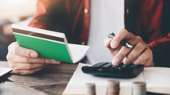 close up photo of checkbook and calculator