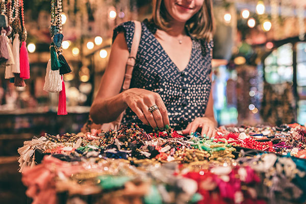 Shopper at market looking at jewelry