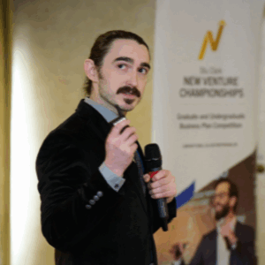 Joshua Upshaw speaking while holding a microphone